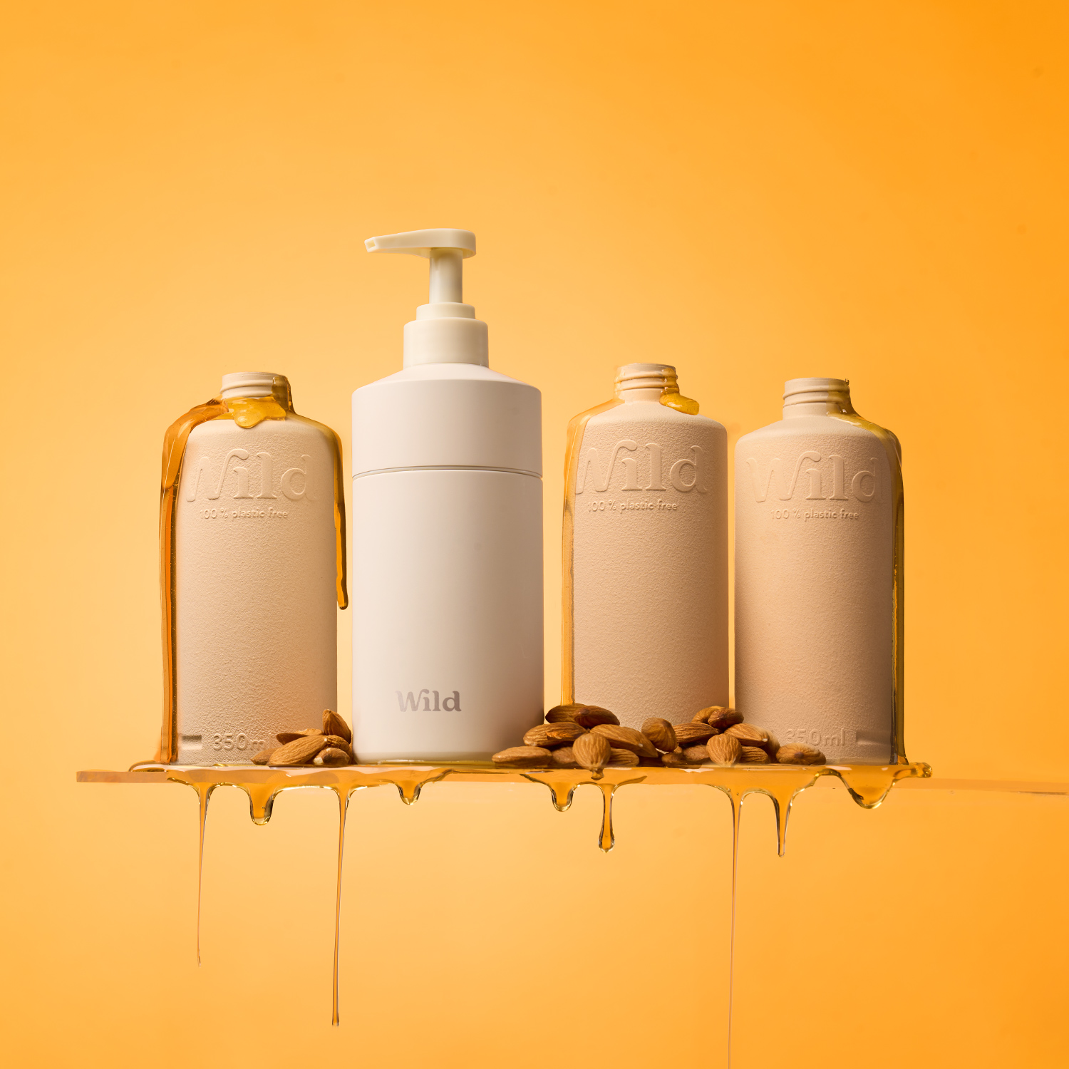 Caption: three bottles of liquid are on a shelf