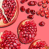 Caption: a bunch of pomegranates on a pink background