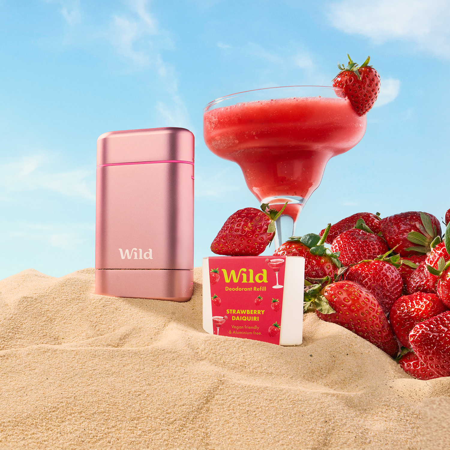 Caption: a pink mp3 player sitting on top of a pile of sand next to a drink
