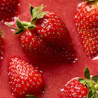 Caption: a group of strawberries sitting on top of a red surface
