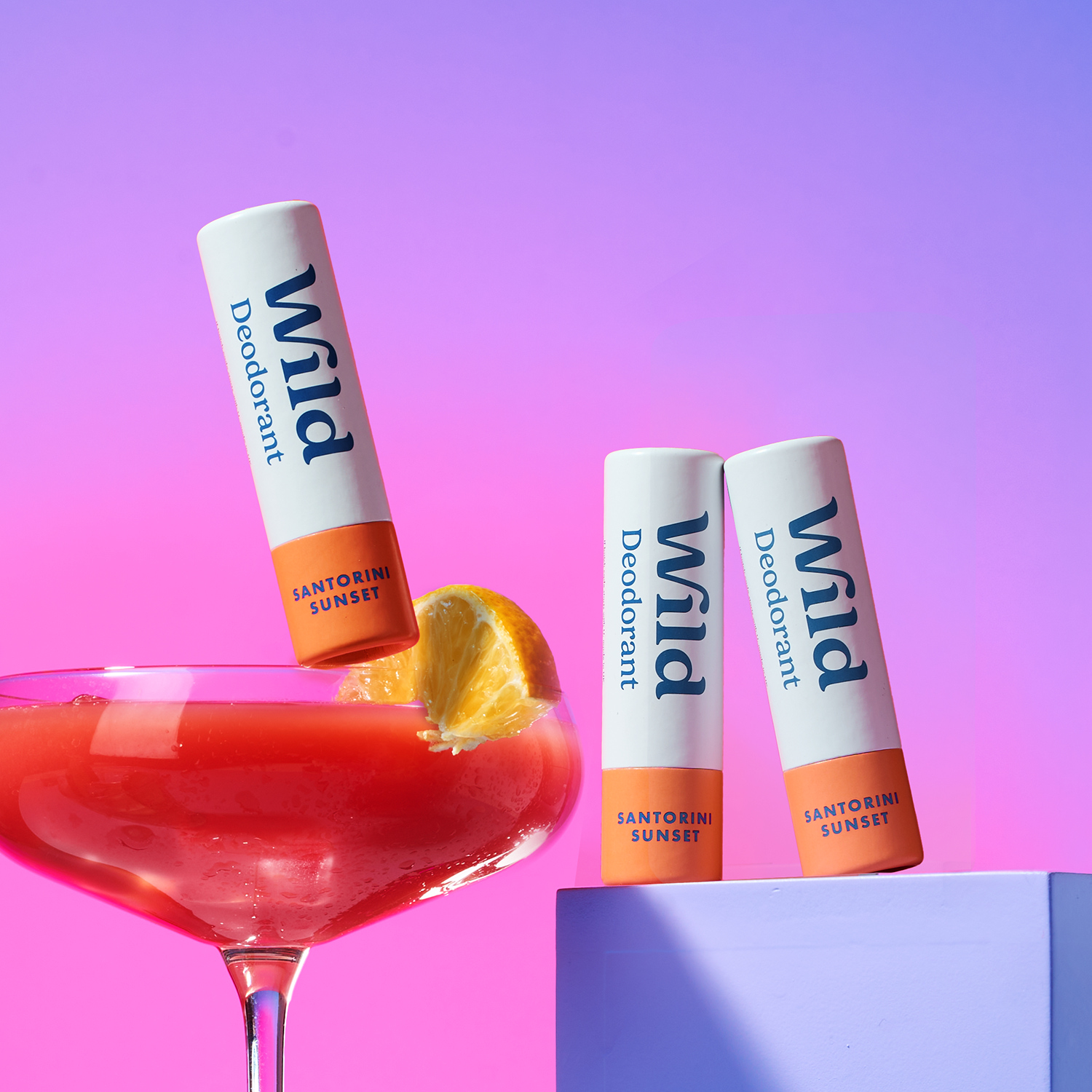 Caption: a glass of red liquid with two lip bales sticking out of it