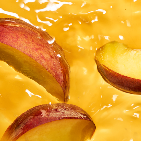 Caption: a sliced apple sitting on top of a yellow liquid