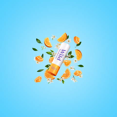 Caption: an orange pill surrounded by leaves and flowers