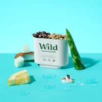 Caption: a can of wild deodorant next to a slice of lemon