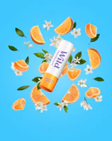 Caption: a tube of lip balm surrounded by orange slices and flowers