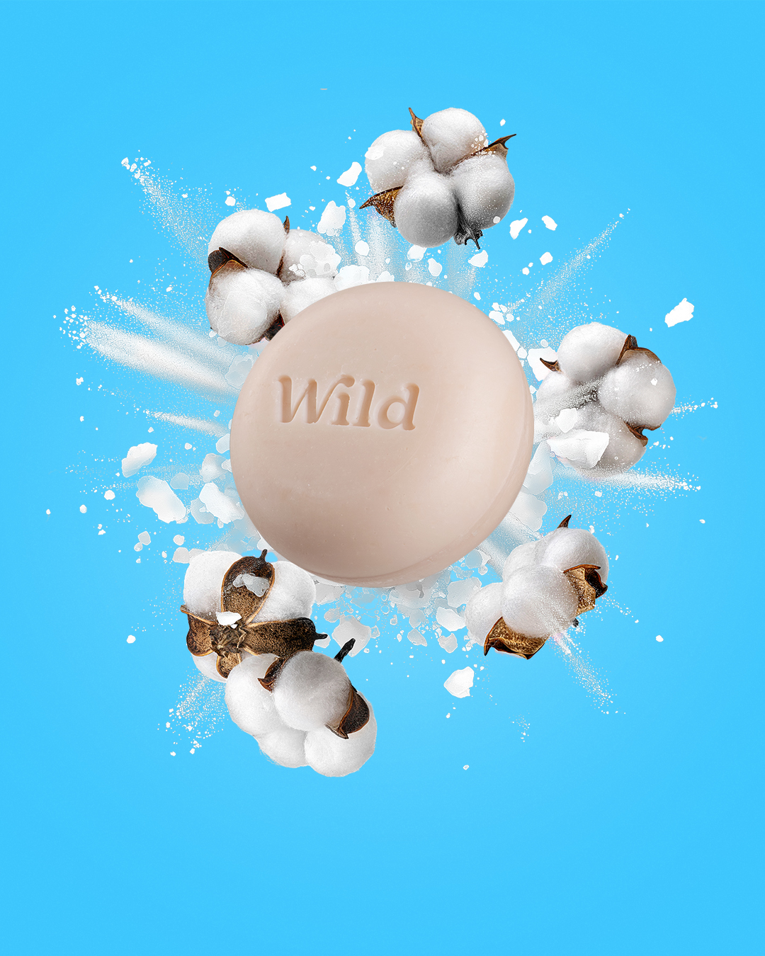 Légende : une boule de savon blanche entourée de flocons de coton