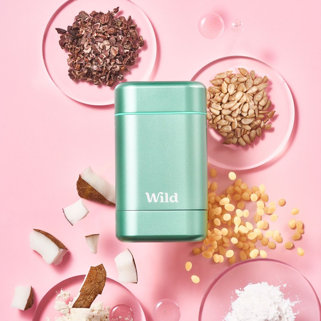 Caption: a pink table topped with plates and bowls filled with food