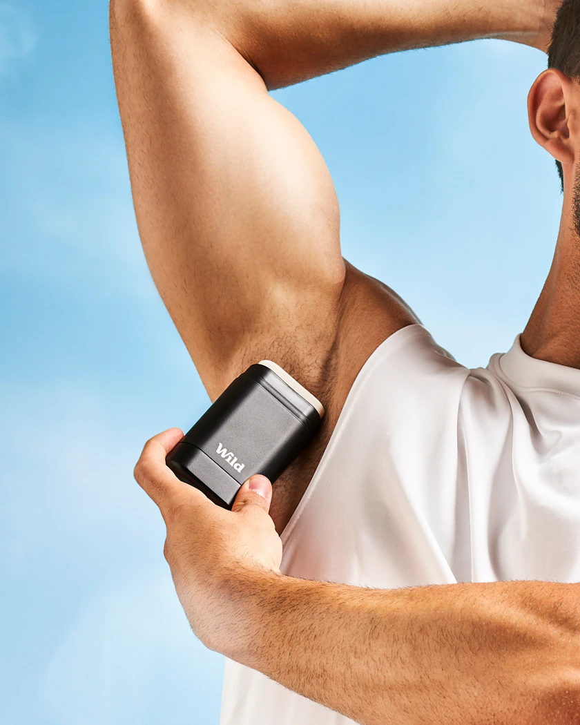 Caption: a man holding a cell phone in his left hand