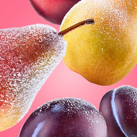 Légende : gros plan de prunes et d'une pomme sur fond rose