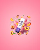 Caption: a tube of lip butter surrounded by peaches