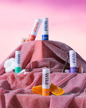 Caption: a pile of lip bales sitting on top of a pink blanket