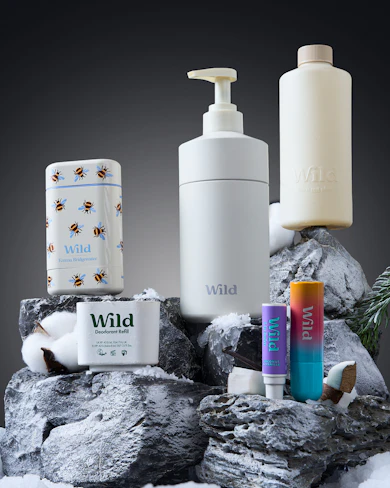 Caption: a couple of bottles of soap sitting on top of a pile of rocks