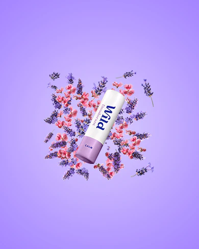 Caption: a tube of lip balm surrounded by flowers