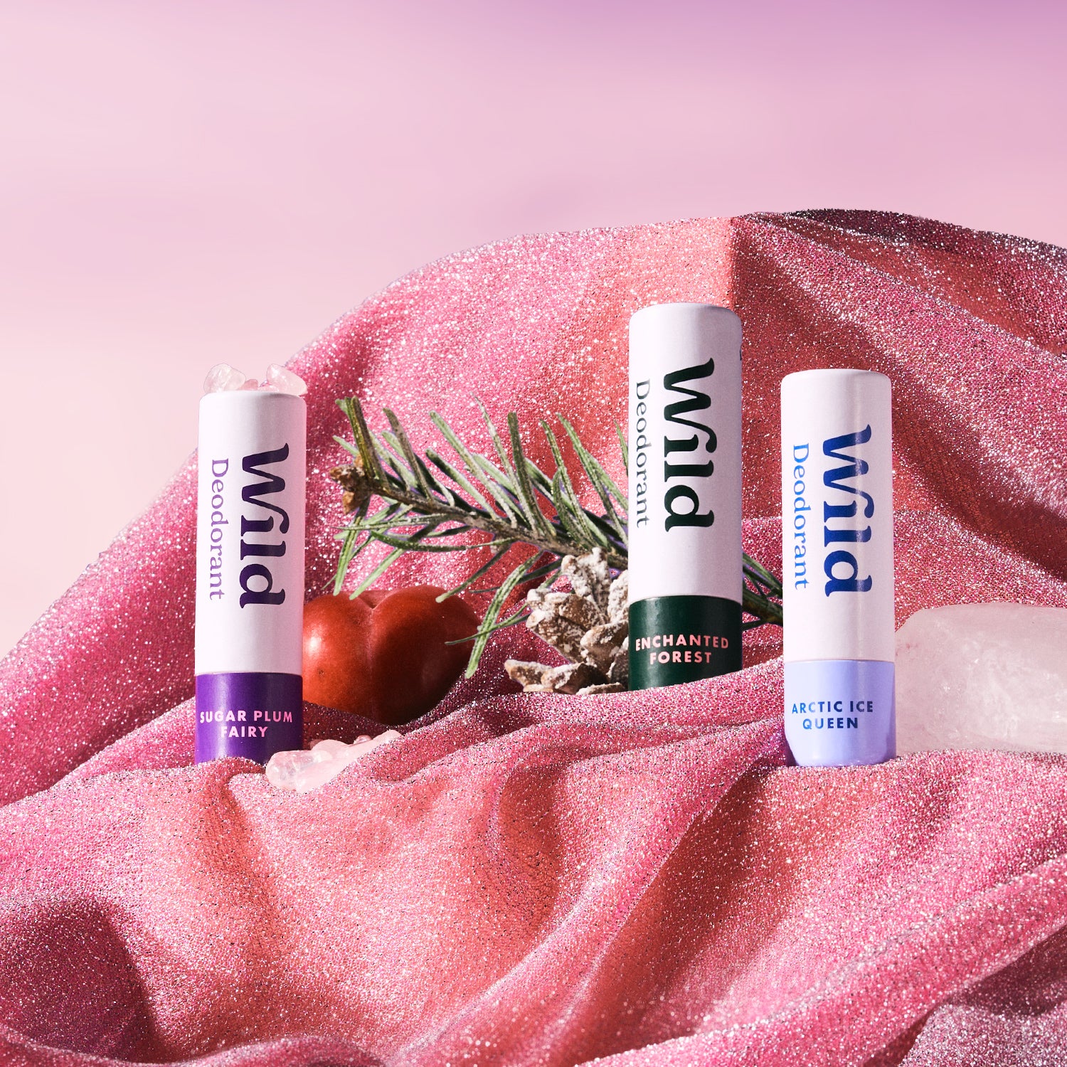 Caption: three lip bales sitting on top of a pink blanket