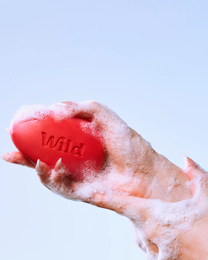 Caption: a person holding a red ball in their hand