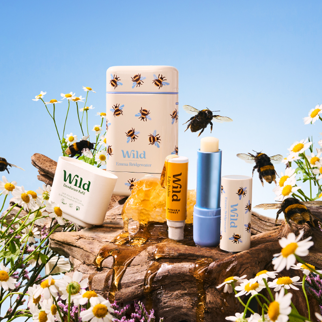 Caption: a group of bees sitting on top of a wooden table