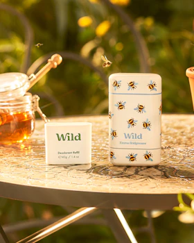 Caption: a table topped with a jar of honey next to a jar of honey
