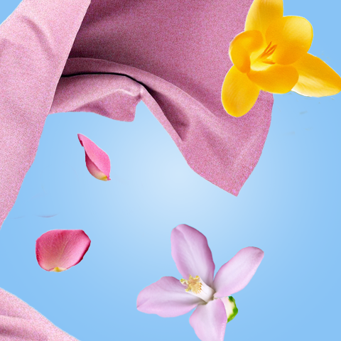 Légende : une couverture rose avec des fleurs jaunes et roses flottant dans l'air