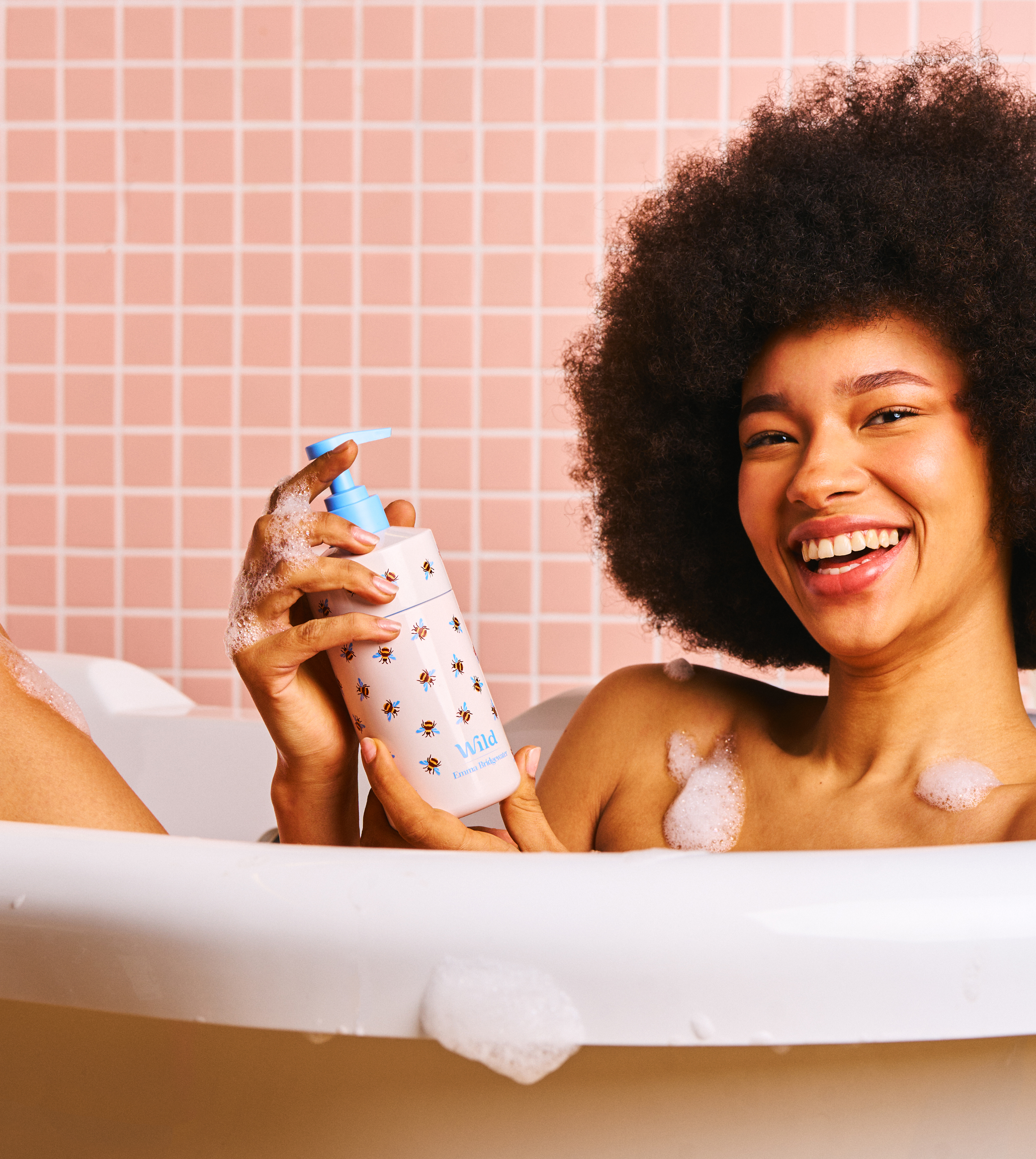 model in bath with bee body wash case