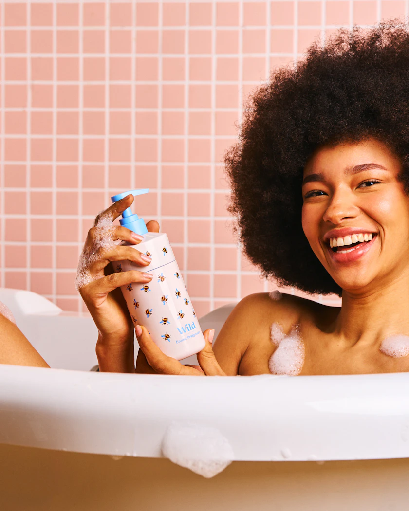model in bath with bee body wash case