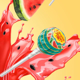 Caption: a slice of watermelon being dropped into a liquid