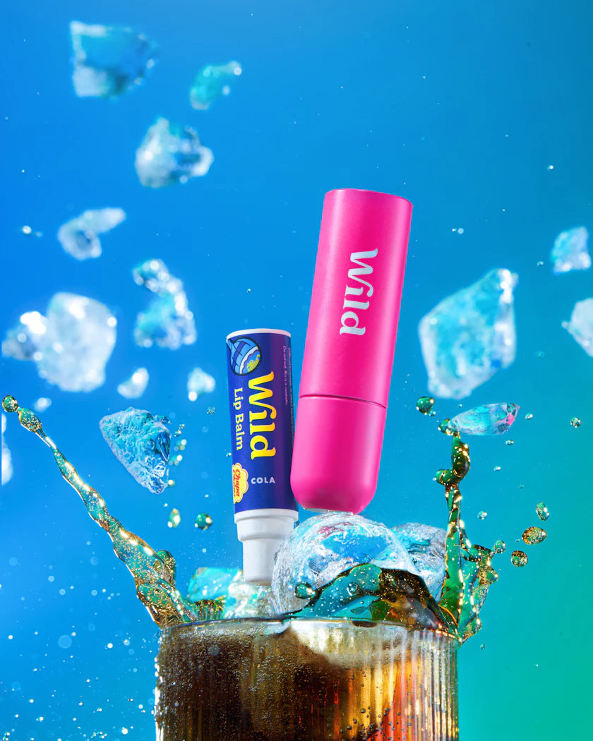 Caption: a tube of lip butter sitting on top of a glass