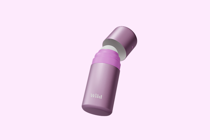 Caption: a purple and white bottle with a pink lid