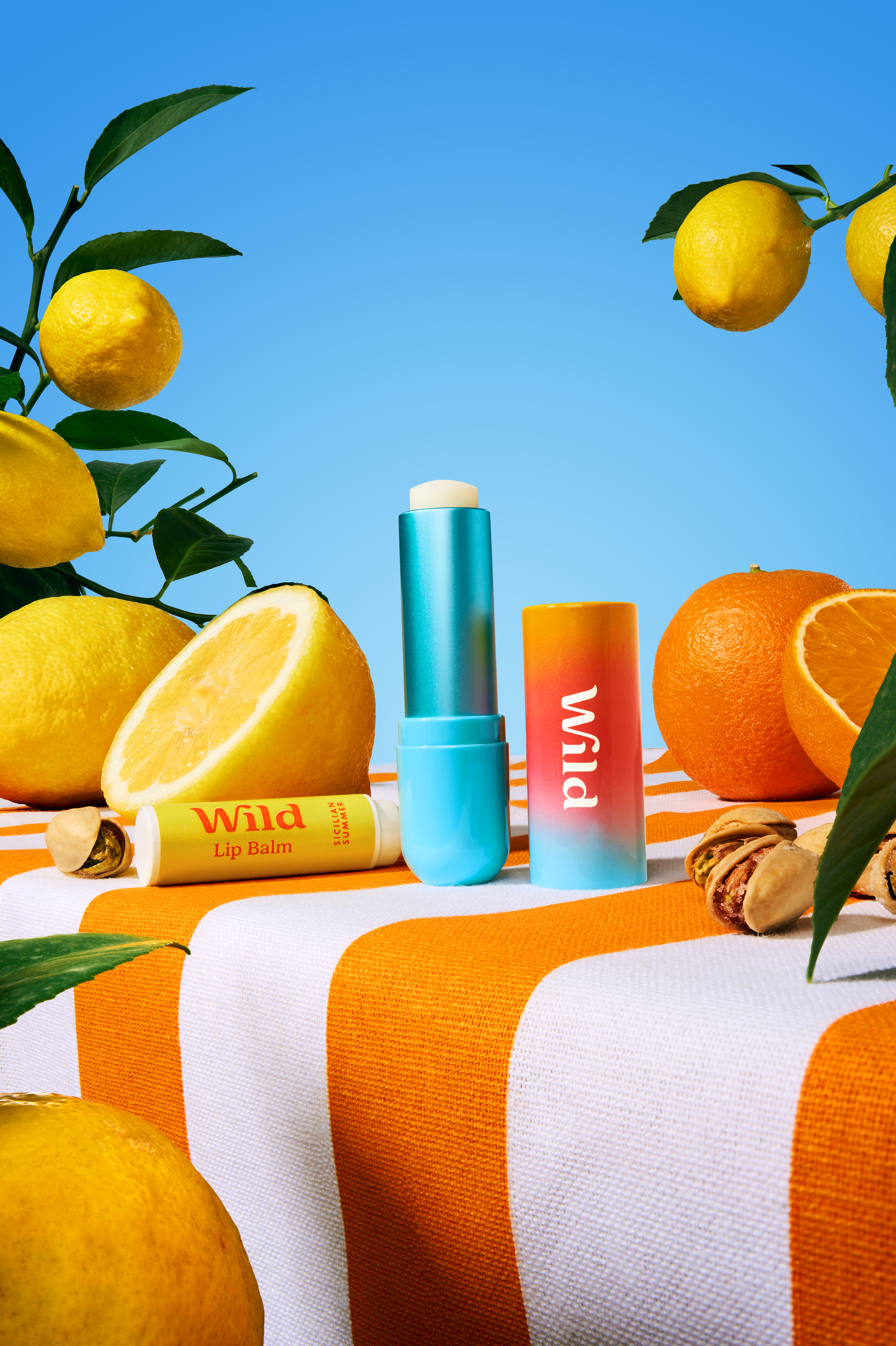 Caption: a table topped with oranges and a tube of lip balm