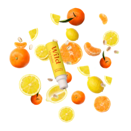 Caption: a tube of lip balm surrounded by oranges and lemons