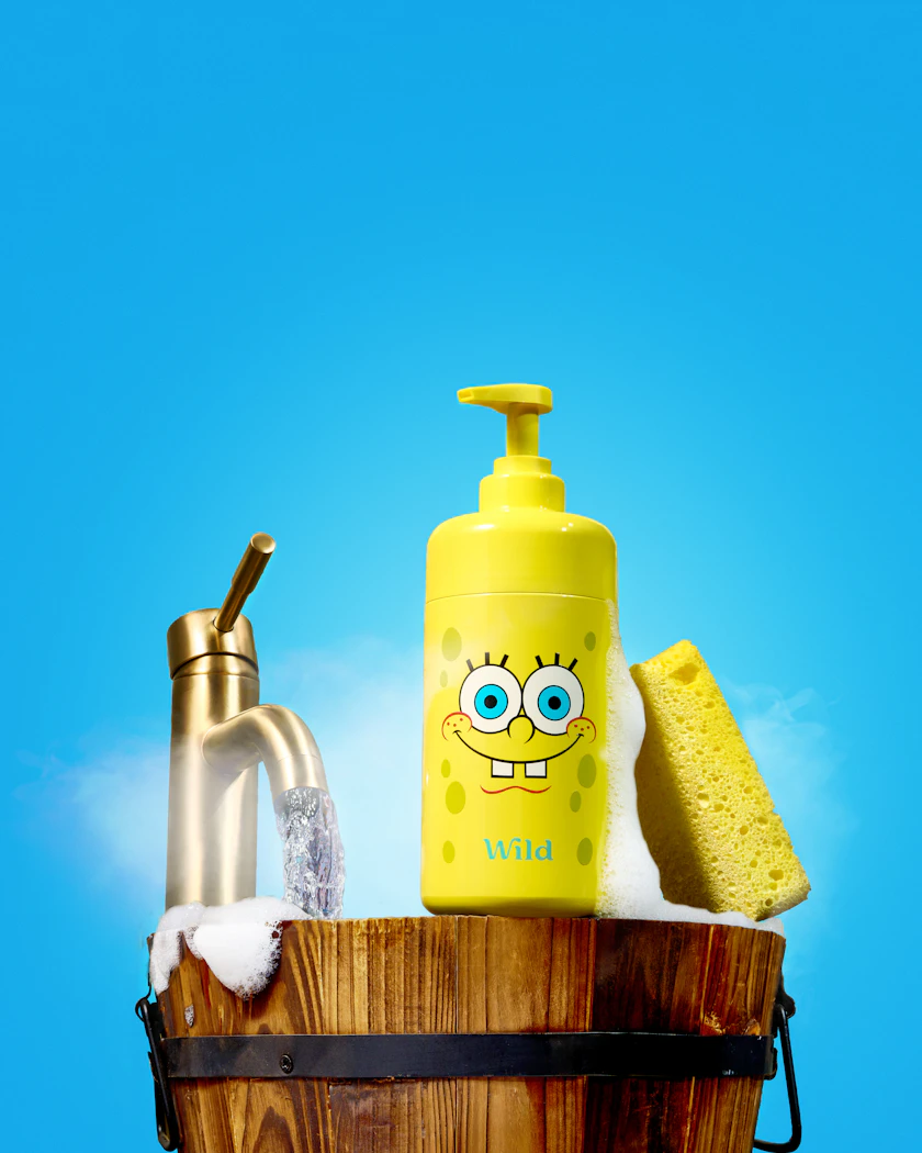 Caption: a spongebob water bottle sitting on top of a wooden bucket