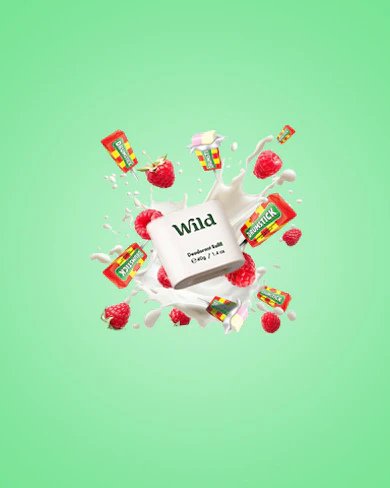 Caption: a milk carton with strawberries and milk falling out of it