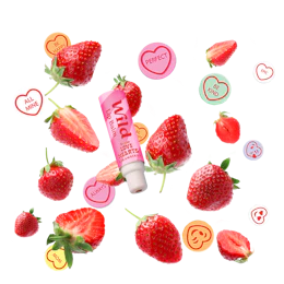 Caption: a tube of lip balm surrounded by strawberries