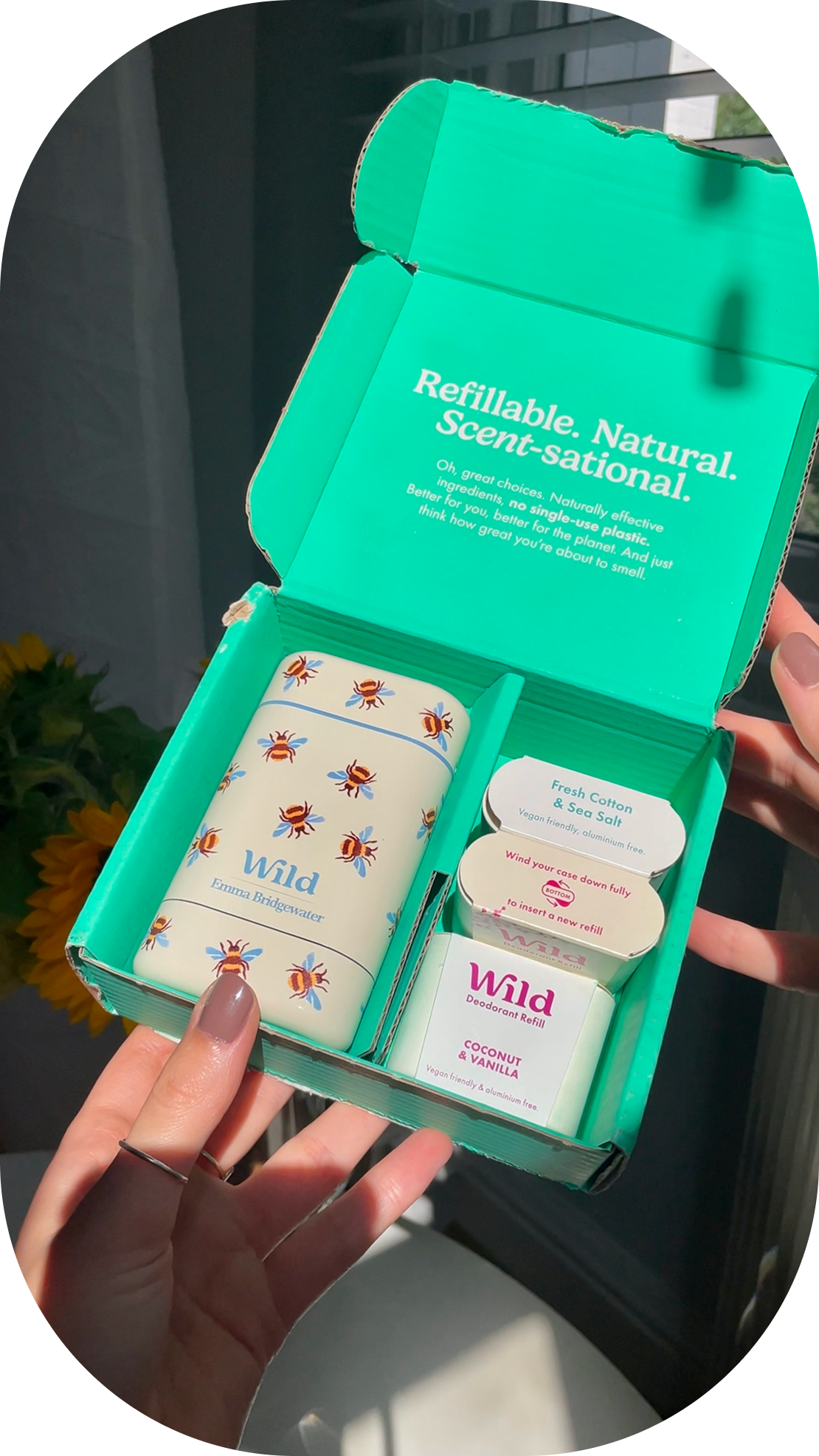 Caption: a person holding a green box with three different items in it