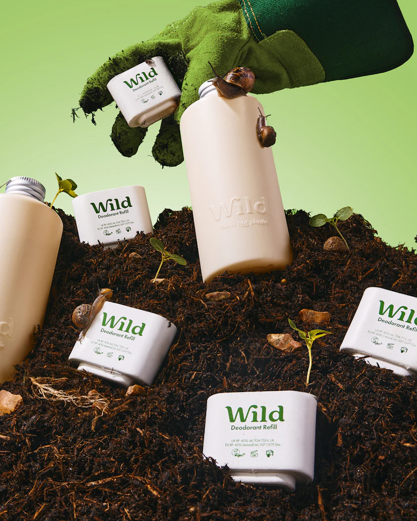 Caption: a hand is holding a can of wild tea