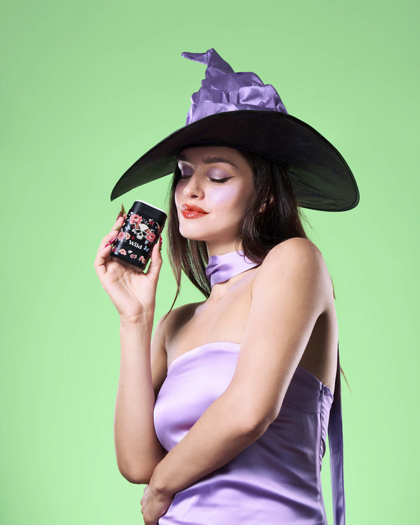 Caption: a woman in a purple dress holding a cell phone