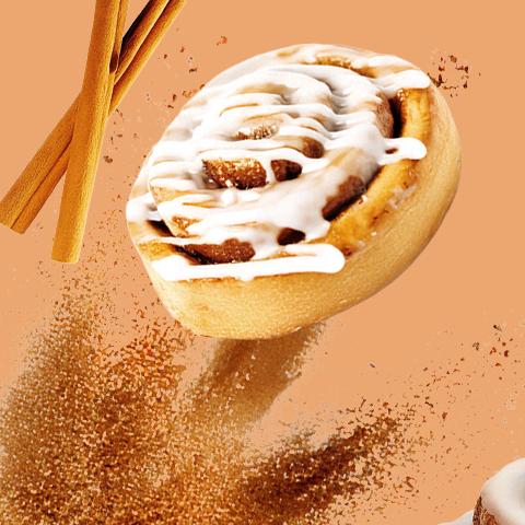 Légende : un rouleau à la cannelle avec un bâton de cannelle qui en sort