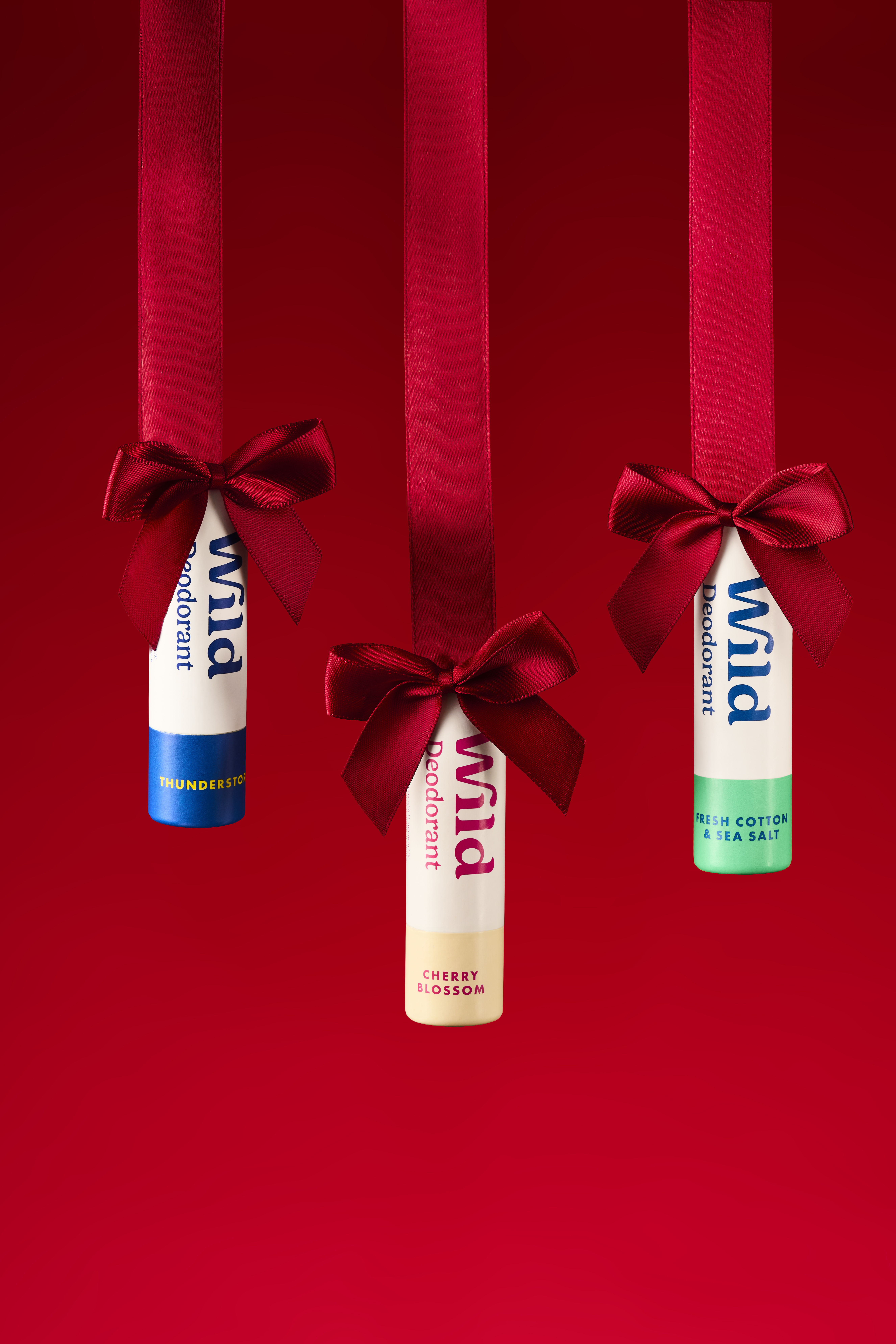 Caption: three tubes of toothpaste tied to a red ribbon