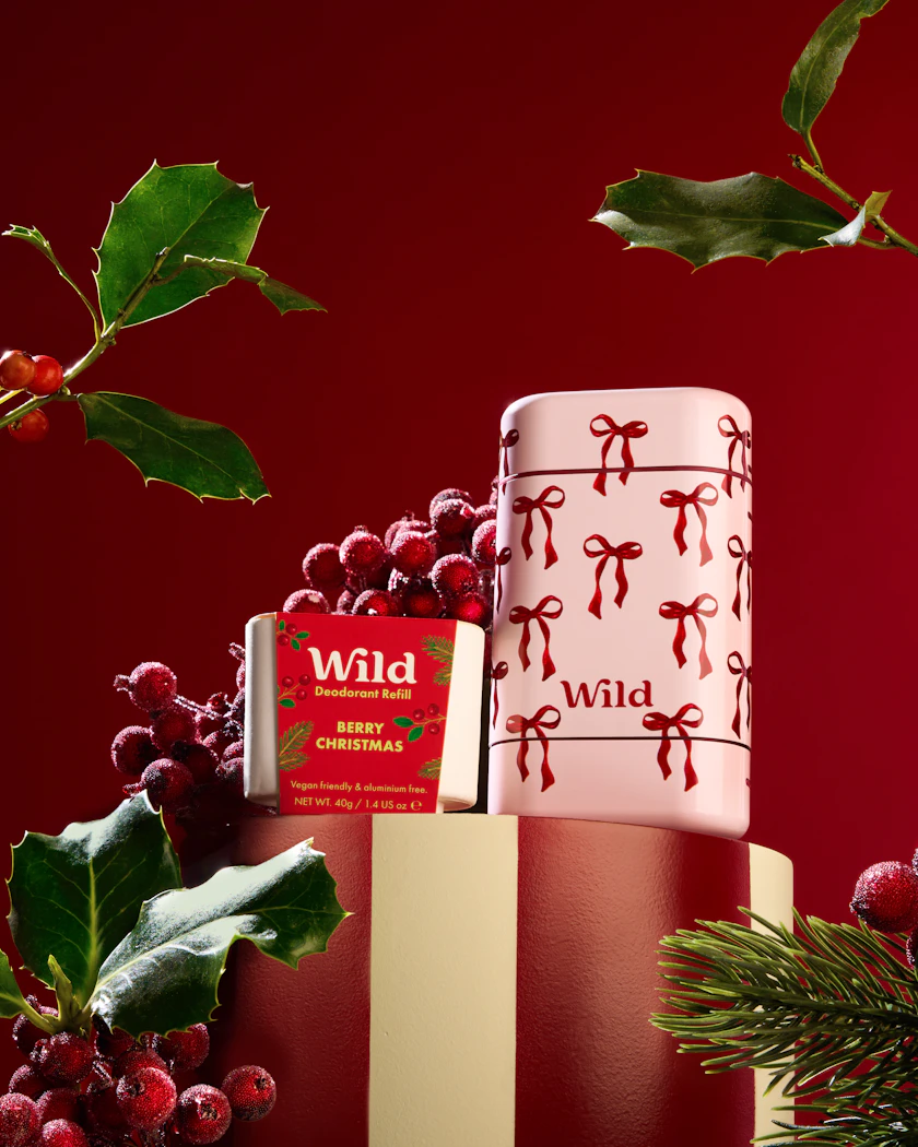 Caption: a red and white christmas cake sitting on top of a table