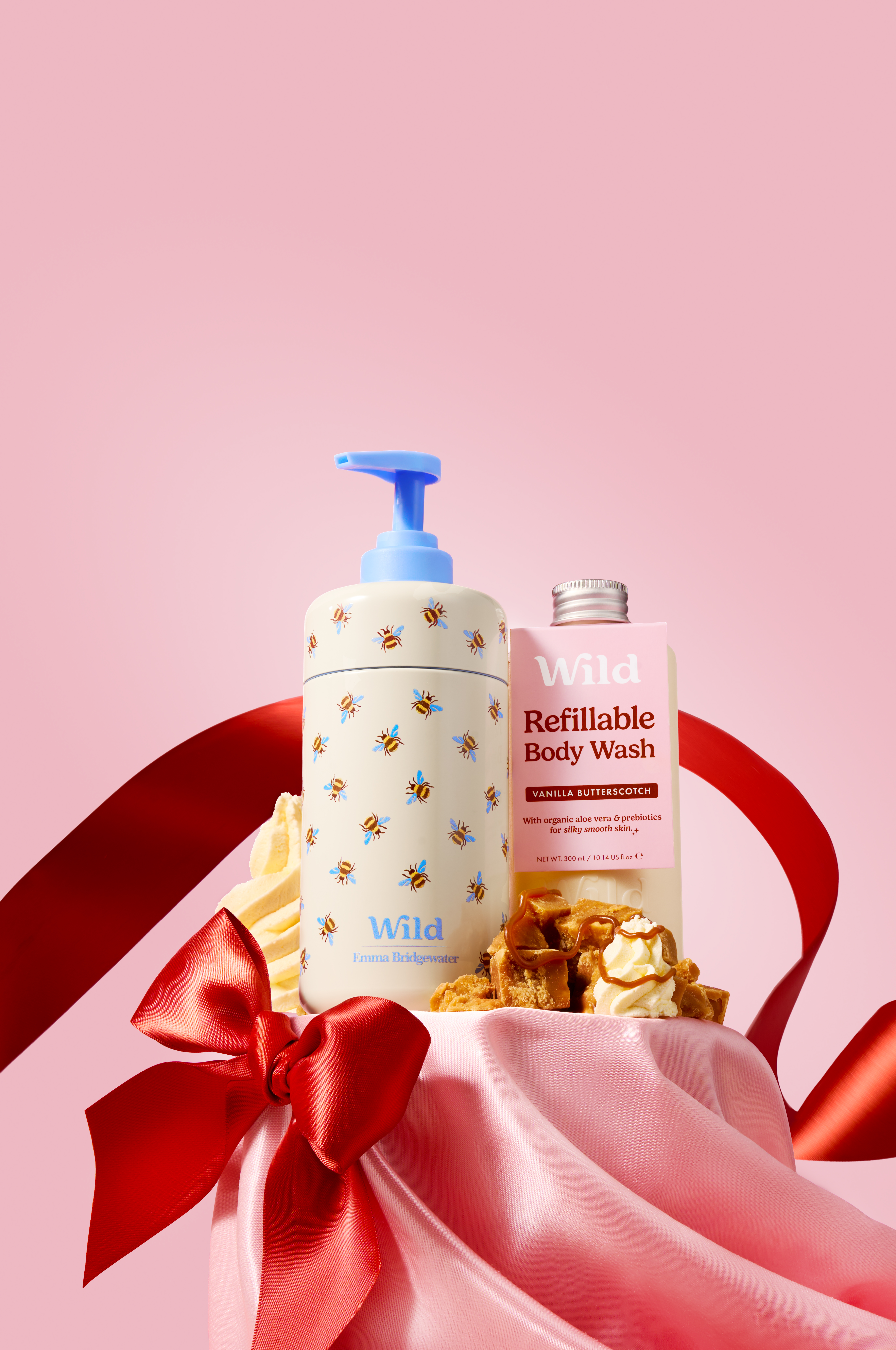 Caption: a bottle of soap and a lotion on a pink background