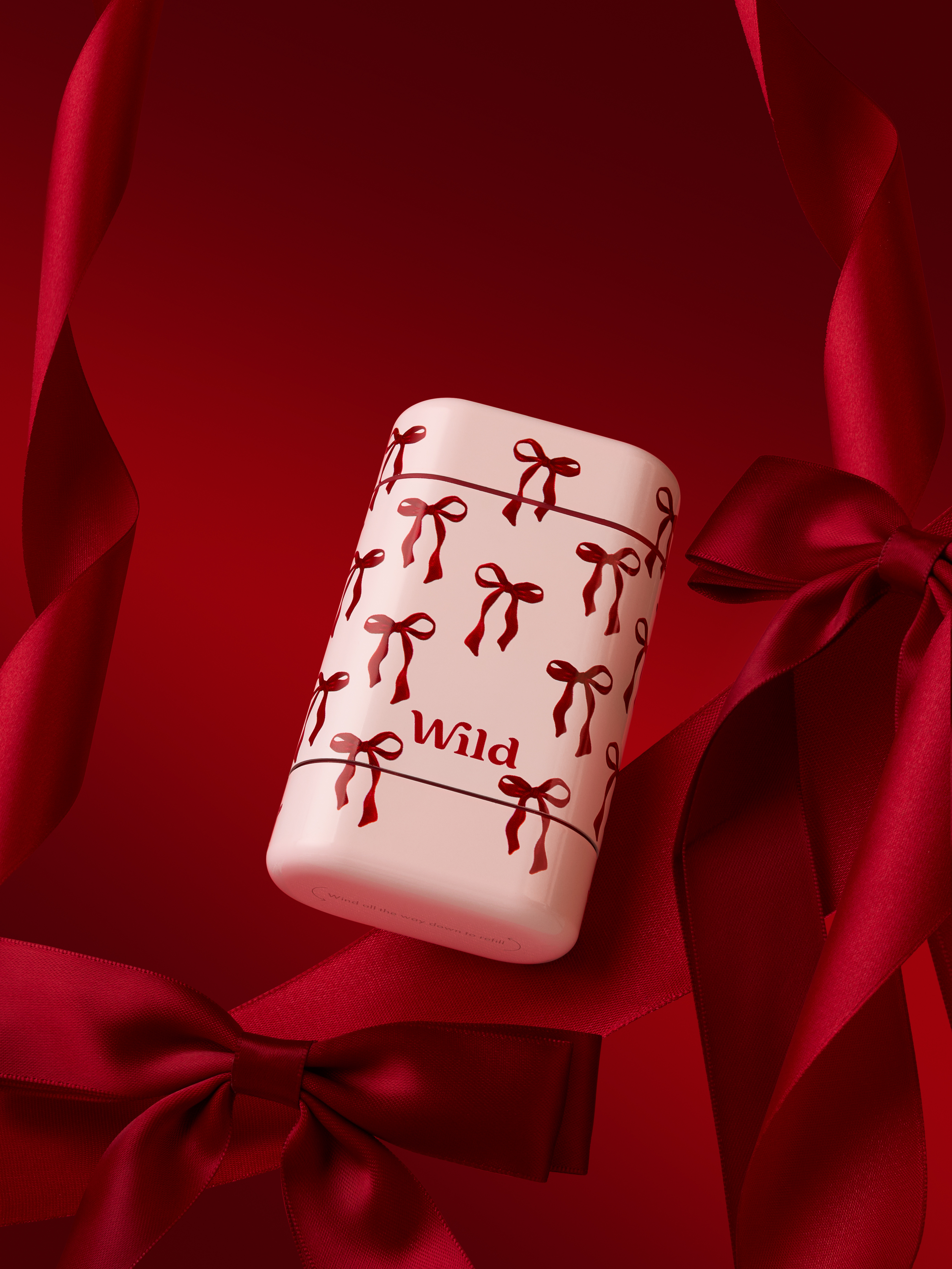 Caption: a red and white ceramic object with bows on it