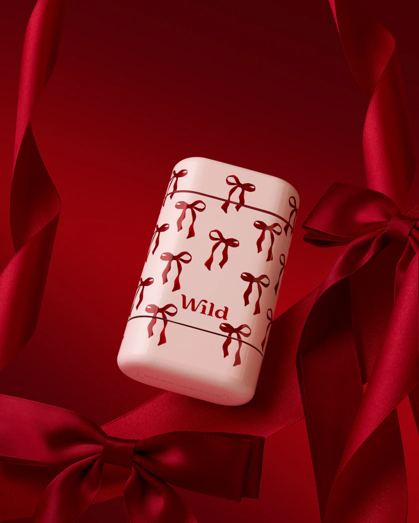 Caption: a red and white ceramic object with bows on it