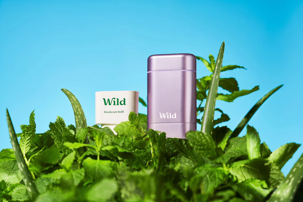 Caption: a purple lighter sitting on top of a lush green plant