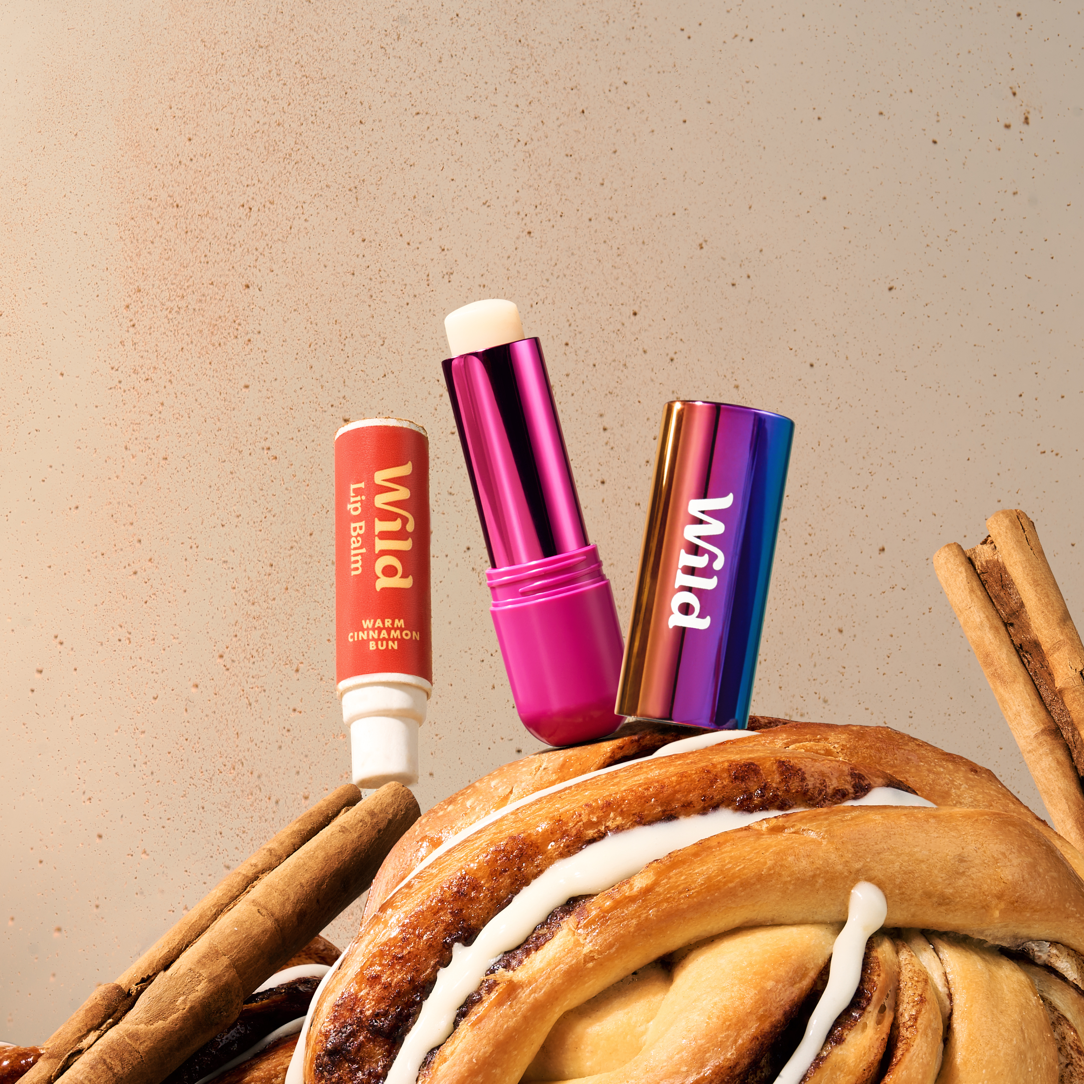 Caption: a pile of cinnamon rolls sitting next to a tube of lip balm