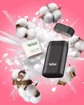 Caption: a pink background with cotton and a black and white soap dispenser