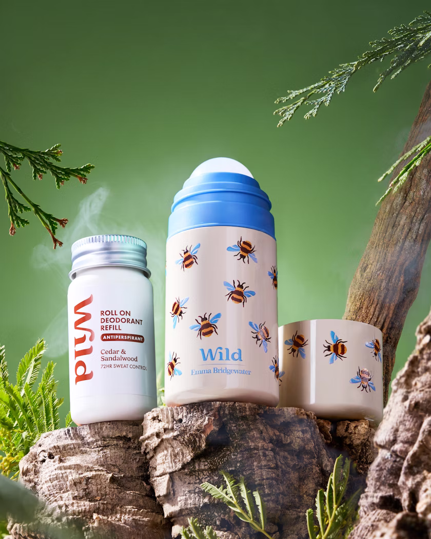 Caption: a couple of jars sitting on top of a tree stump