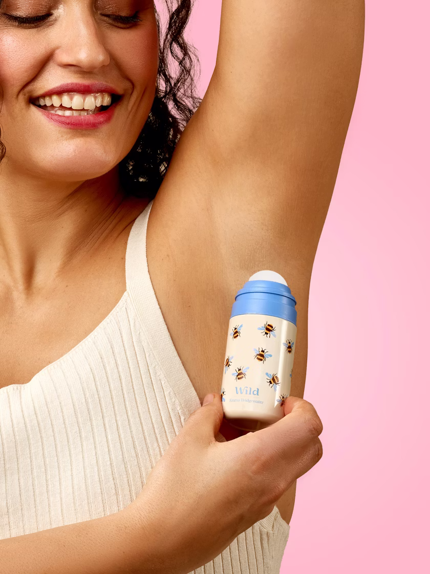 Caption: a woman holding a baby bottle in her right arm