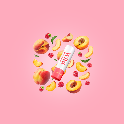 Caption: a tube of lip butter surrounded by peaches and raspberries