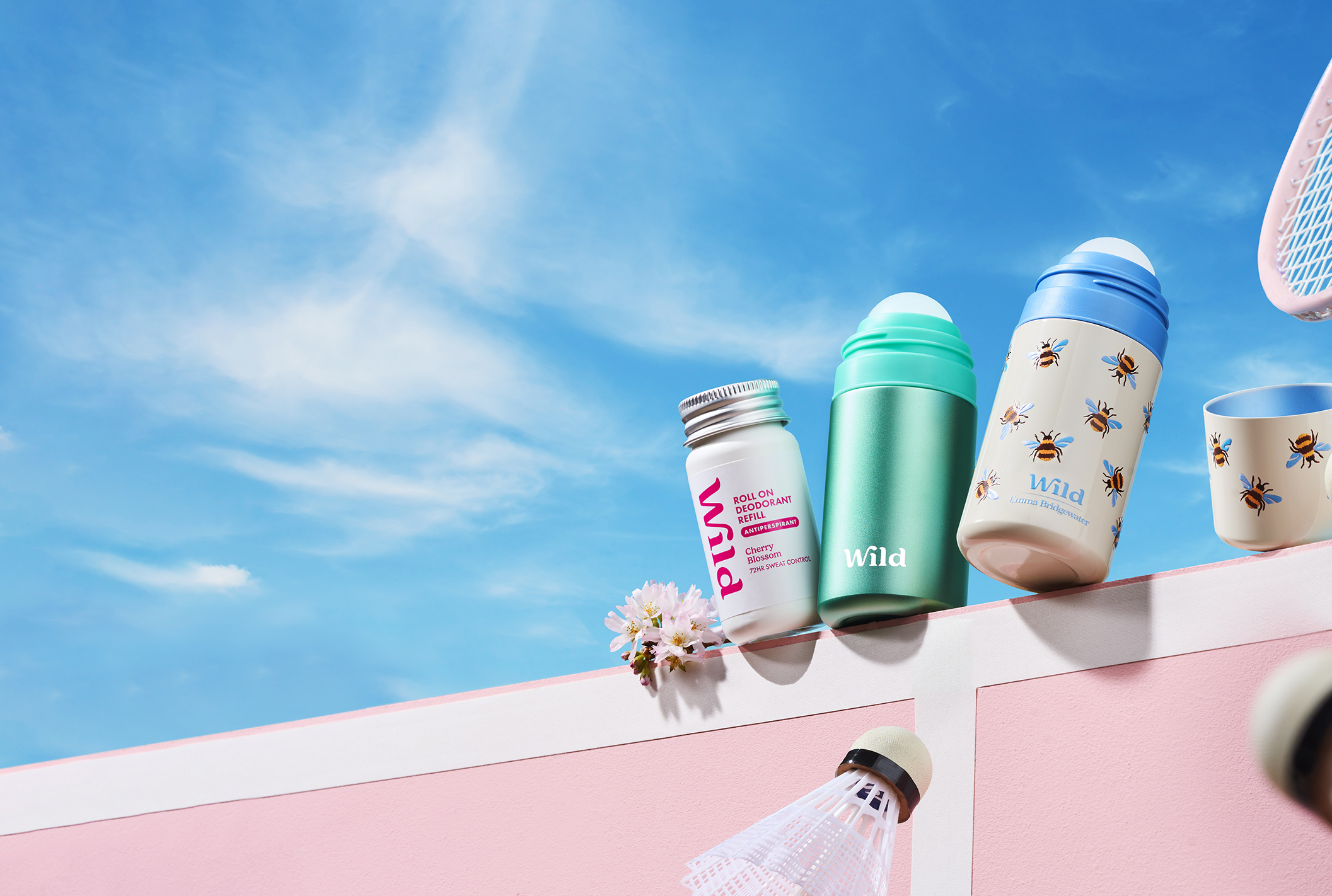 Caption: a pink wall with a bunch of items on top of it