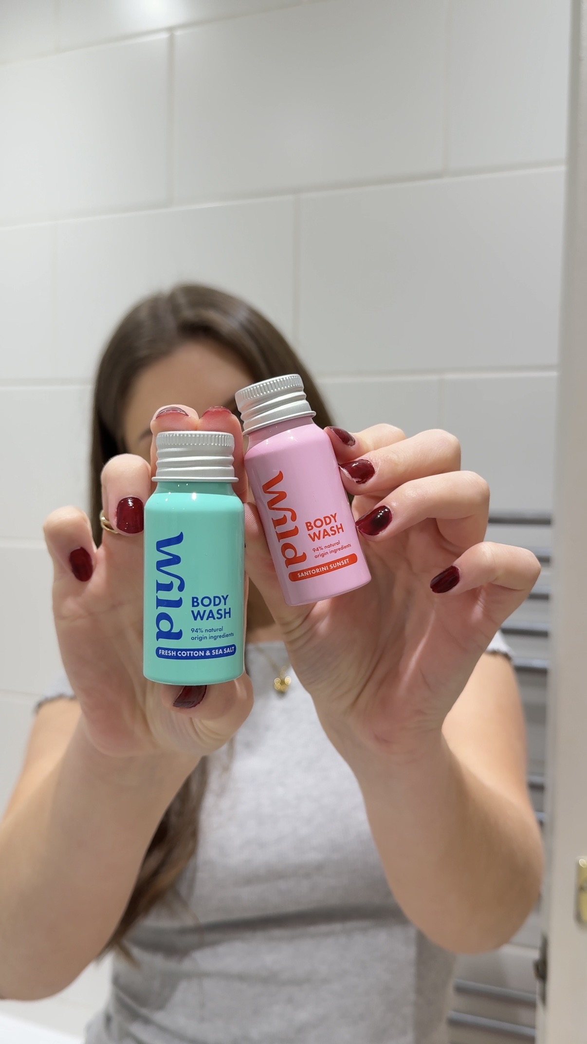Caption: a woman holding two different types of hair products