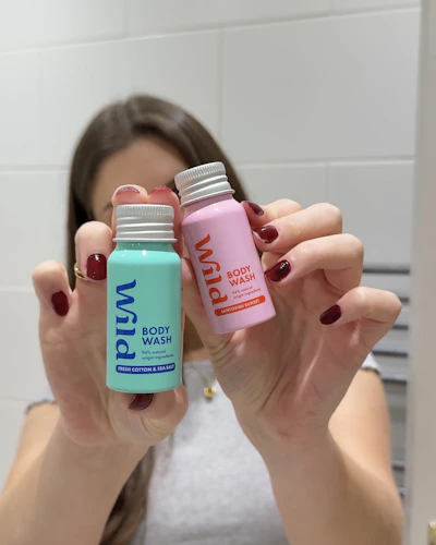 Caption: a woman holding two different types of hair products